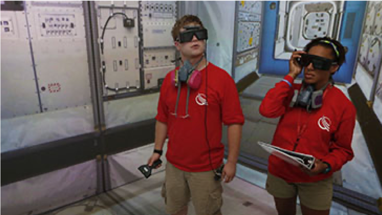 Image of two people staring in a virtual reality simulator