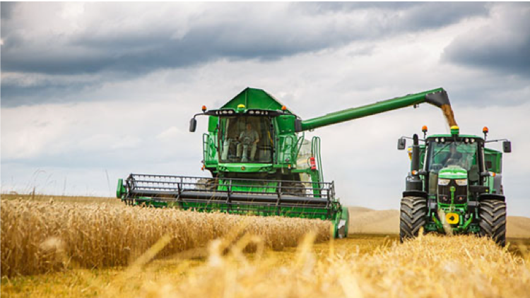 A tractor being loaded with soybean