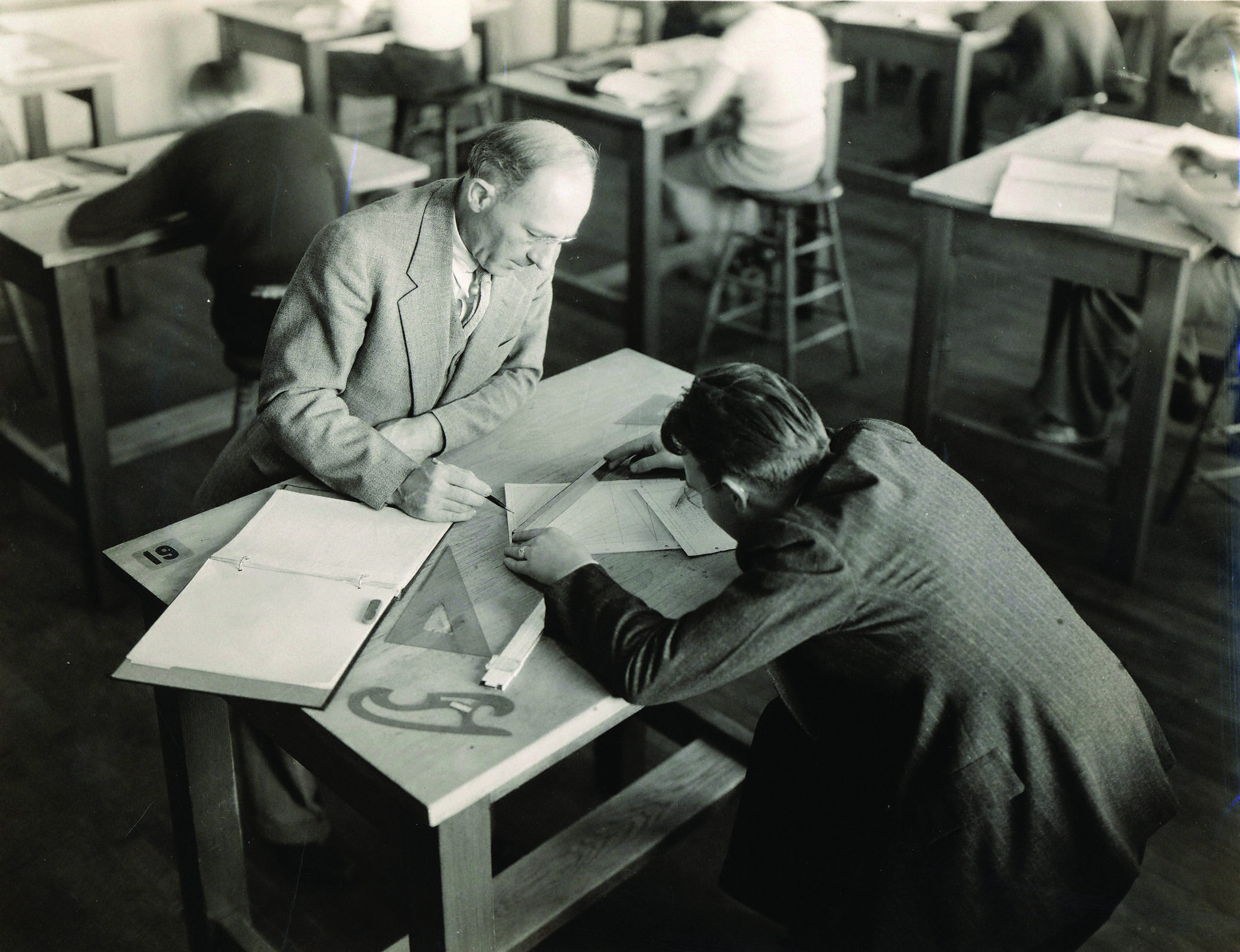 professor and student at drafting table