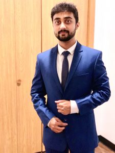 Industrial engineering graduate student Jay Ghodke poses in a blue suit.