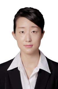 Industrial engineering graduate student Zhuoyi Zhao poses wearing a dark suit jacket and a light-colored collared shirt.