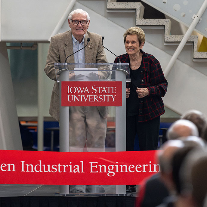 C.G. “Turk” and Joyce A. McEwen Therkildsen stand at a podium addressing the crowd during building dedication event