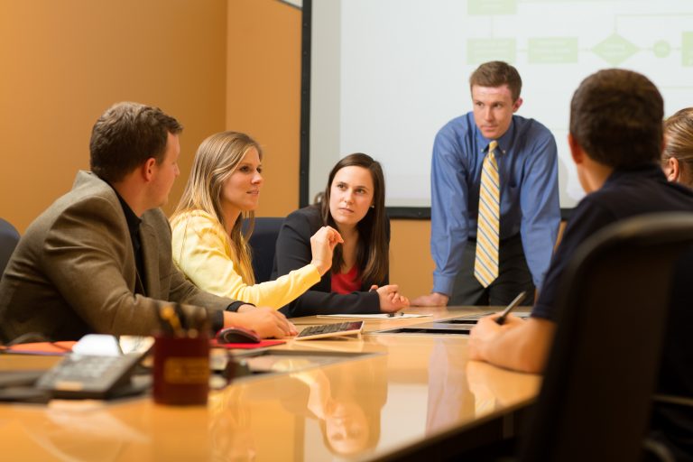 People converse at a business meeting.